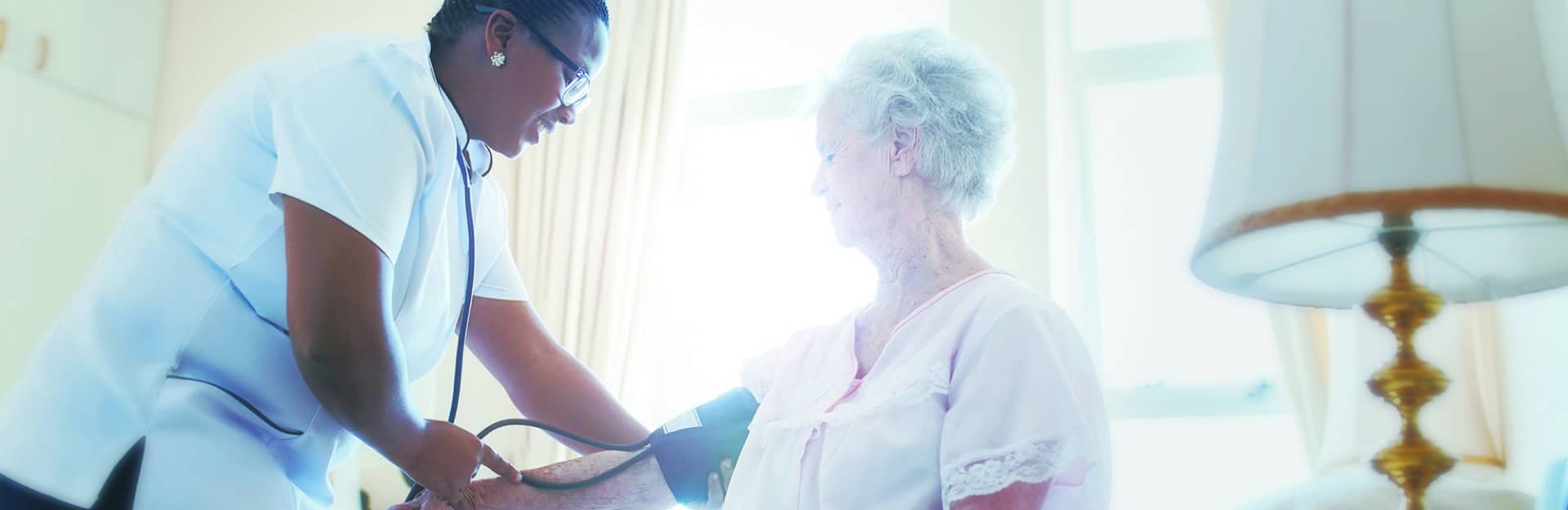 VNA worker testing resident's blood pressure