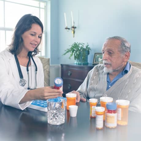 TGH Home Care caregiver reviewing medications